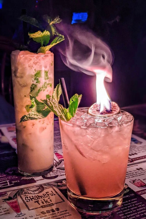 An image of a cocktail on fire in a bar in Toronto